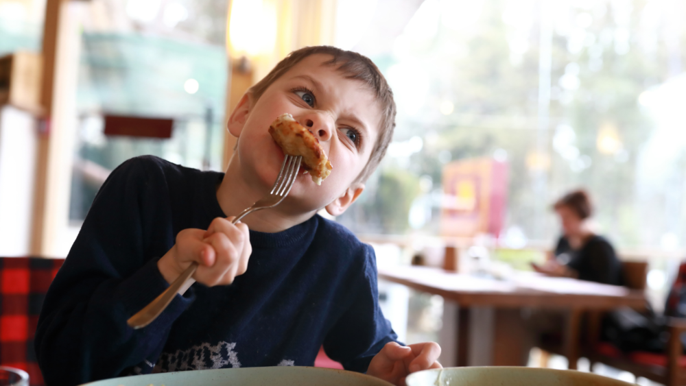 child eating at restaurant
