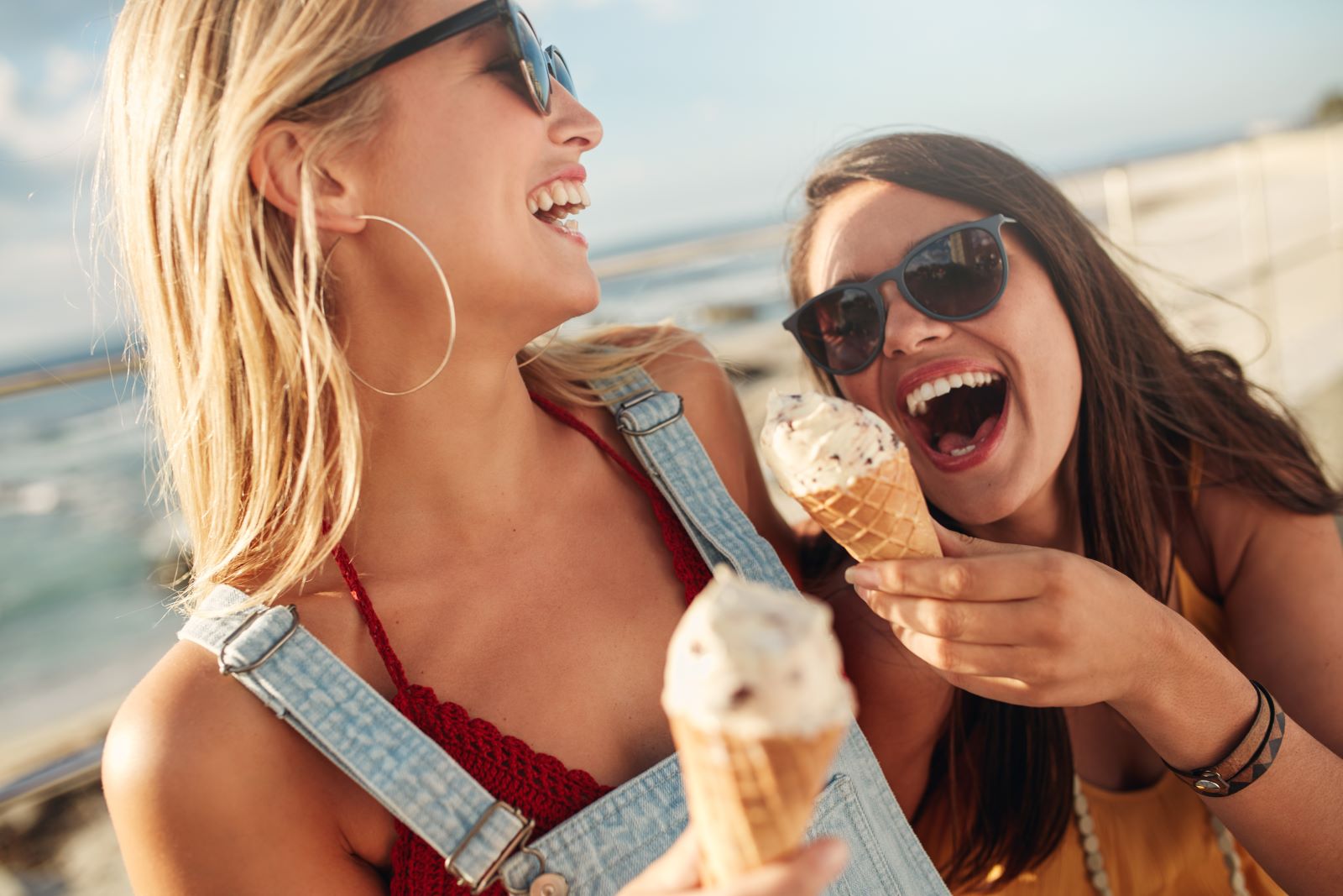 Two friends enjoying ice cream cones on Marco Island beach
