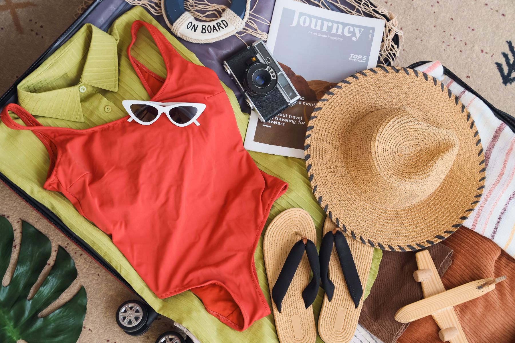 a suitcase filled with clothes for a beach trip